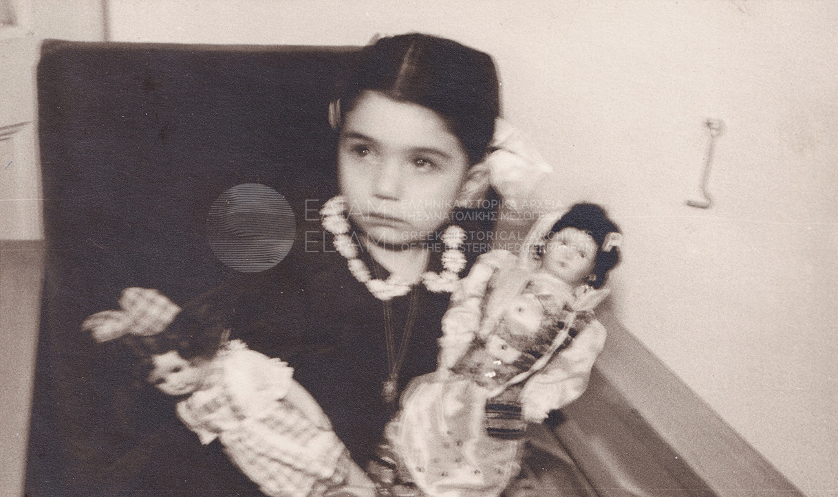 Young girl holding her dolls